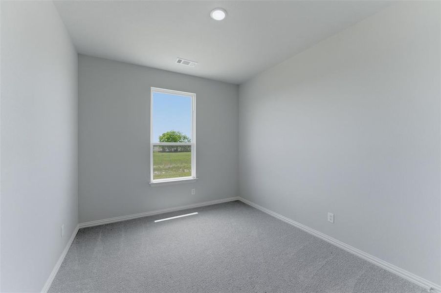 Light gray interior walls with white baseboards and trim, complemented by gray carpeting Light gray interior walls with white baseboards and trim, complemented by gray carpeting