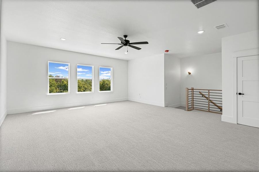 Empty room featuring light carpet, recessed lighting, and a ceiling fan Empty room featuring light carpet, recessed lighting, and a ceiling fan
