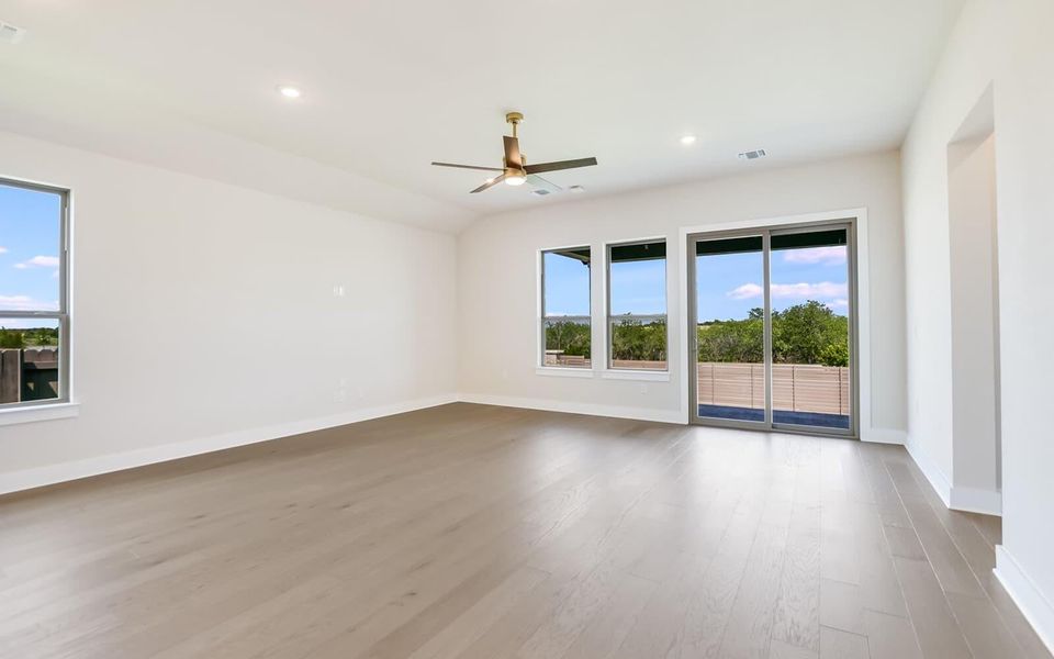 Spare room with a ceiling fan, light wood-style flooring, and recessed lighting