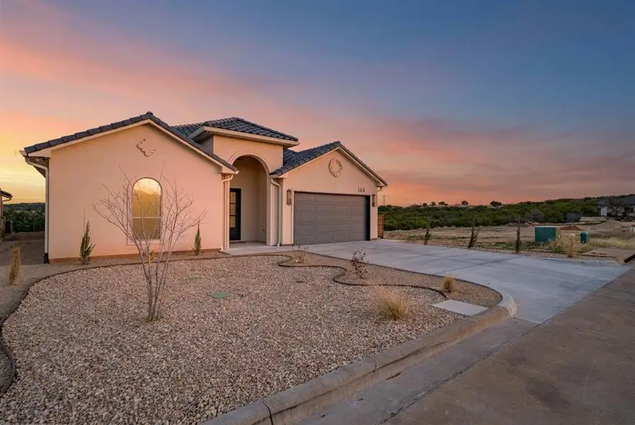 Front exterior of a new home in , Glen Rose, TX, highlighting curb appeal (Image 23). Front exterior of a new home in , Glen Rose, TX, highlighting curb appeal (Image 23).