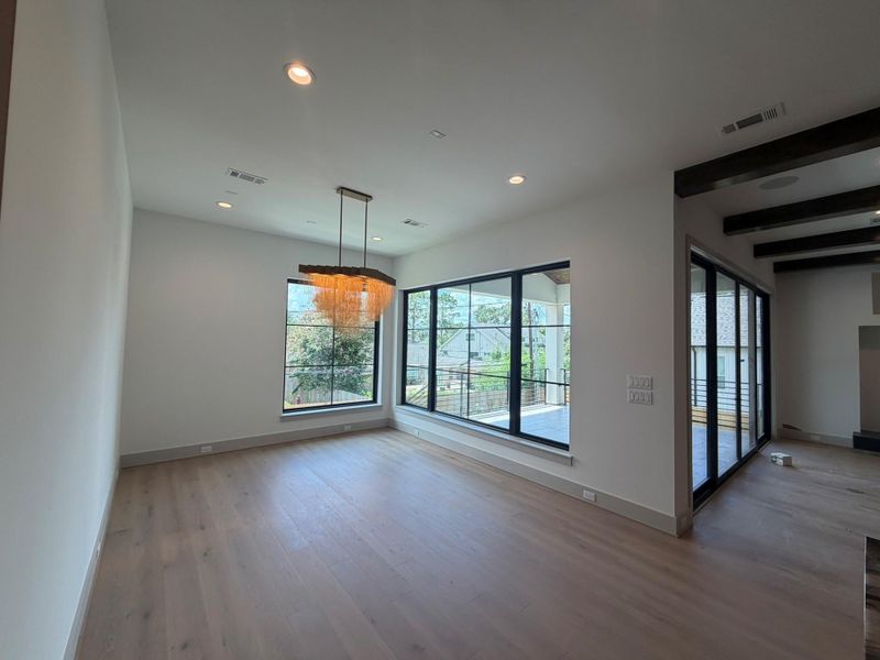 Note the walls of windows overlooking the veranda and back yard areas. The custom chandelier elevates the space. This is a progress picture from August 11.