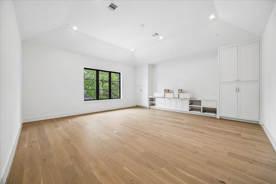 Spacious game room with custom cabinetry.