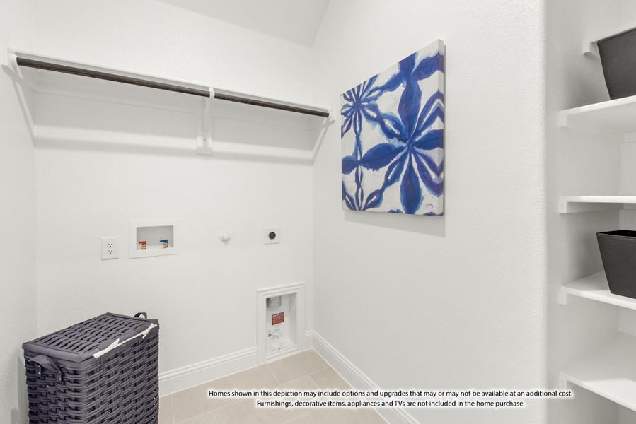 Laundry room with white walls, hanging rod, built-in shelves, and washer and dryer hookups Laundry room with white walls, hanging rod, built-in shelves, and washer and dryer hookups