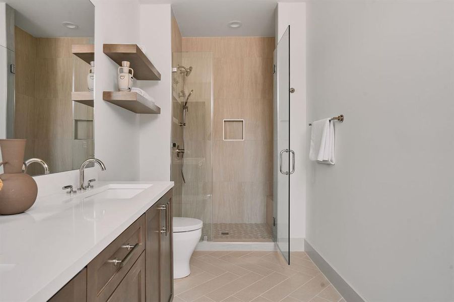 Contemporary bathroom featuring a spacious glass-enclosed shower with tiled walls and a recessed niche