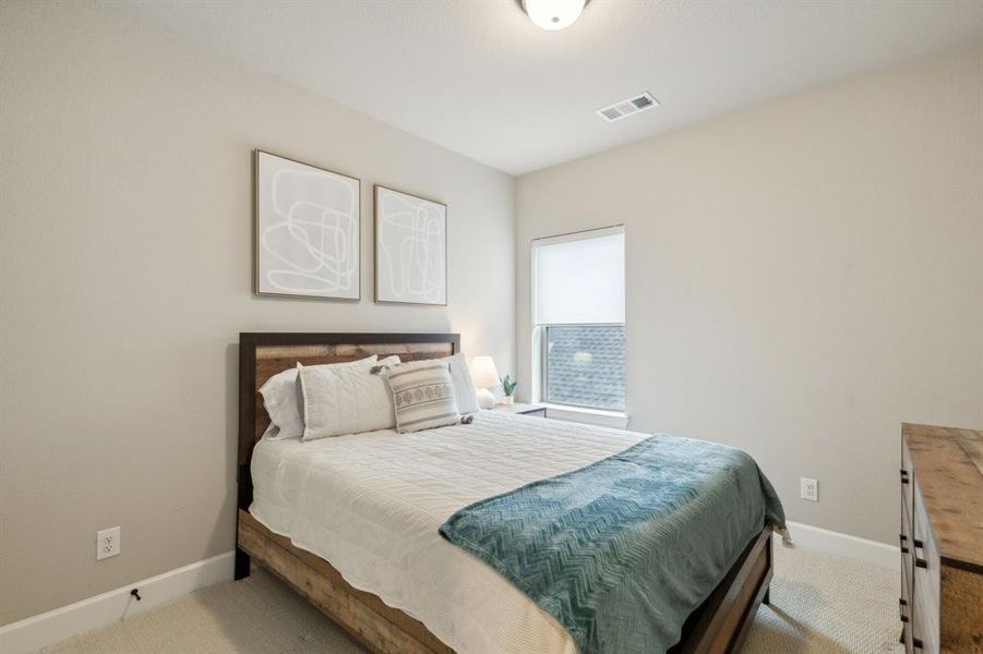 Bedroom featuring light colored carpet