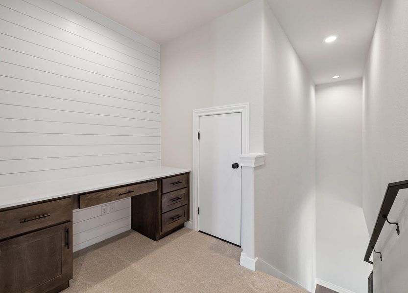 Unfurnished office featuring recessed lighting, built in study area, light carpet, and baseboards Unfurnished office featuring recessed lighting, built in study area, light carpet, and baseboards