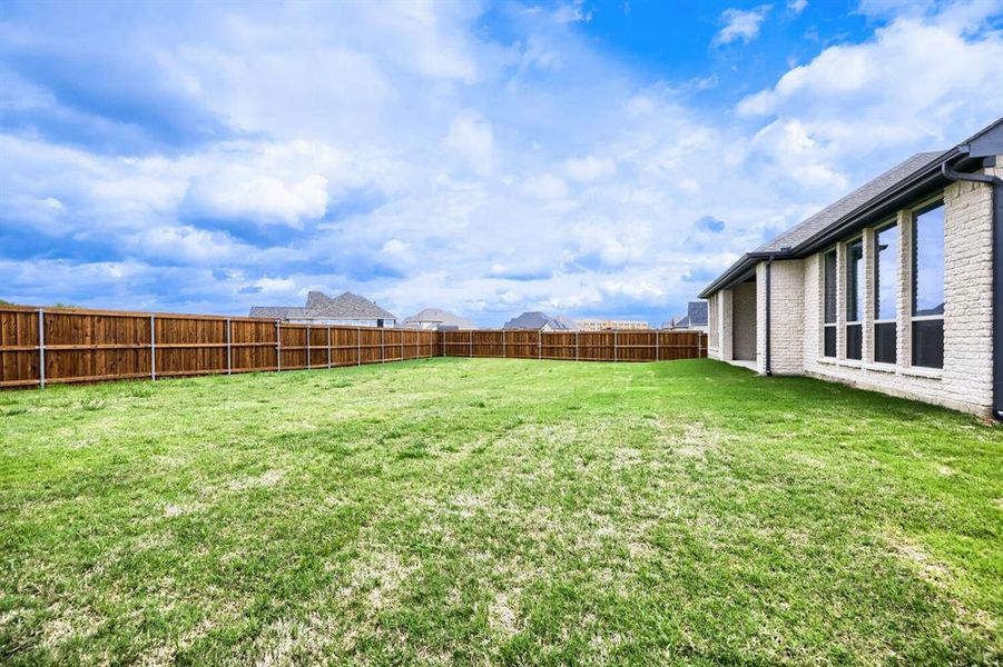 View of fenced backyard