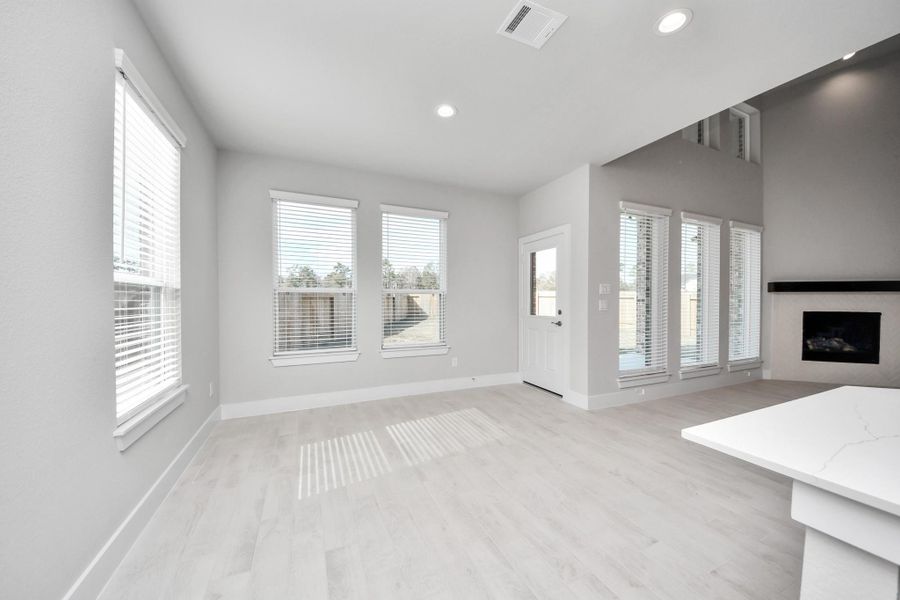 Enjoy breakfast with ease in the connected and cozy breakfast area, seamlessly integrated with the kitchen for utmost convenience. Step through the back door for a breath of fresh air onto the covered patio, extending your living space to the outdoors.