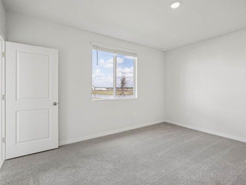 Spacious, unfurnished interior of a new home in The Grove at Stuart Crossing - Premier Series, Bartow (Image 11).