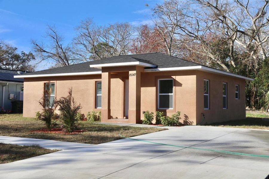 Front exterior of a new home in , Hudson, FL, highlighting curb appeal (Image 28). Front exterior of a new home in , Hudson, FL, highlighting curb appeal (Image 28).