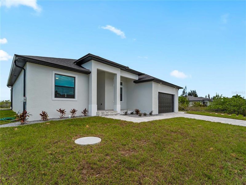 Front exterior of a new home in , Port Charlotte, FL, highlighting curb appeal (Image 30). Front exterior of a new home in , Port Charlotte, FL, highlighting curb appeal (Image 30).