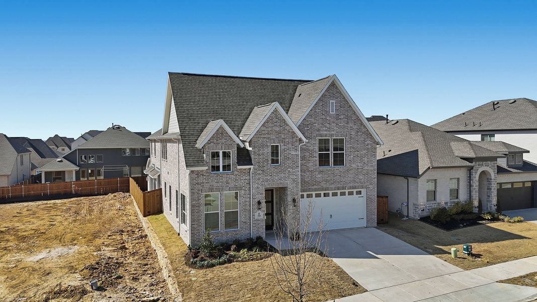 Front exterior of a new home in Tavolo Park, Fort Worth, TX, highlighting curb appeal (Image 26).