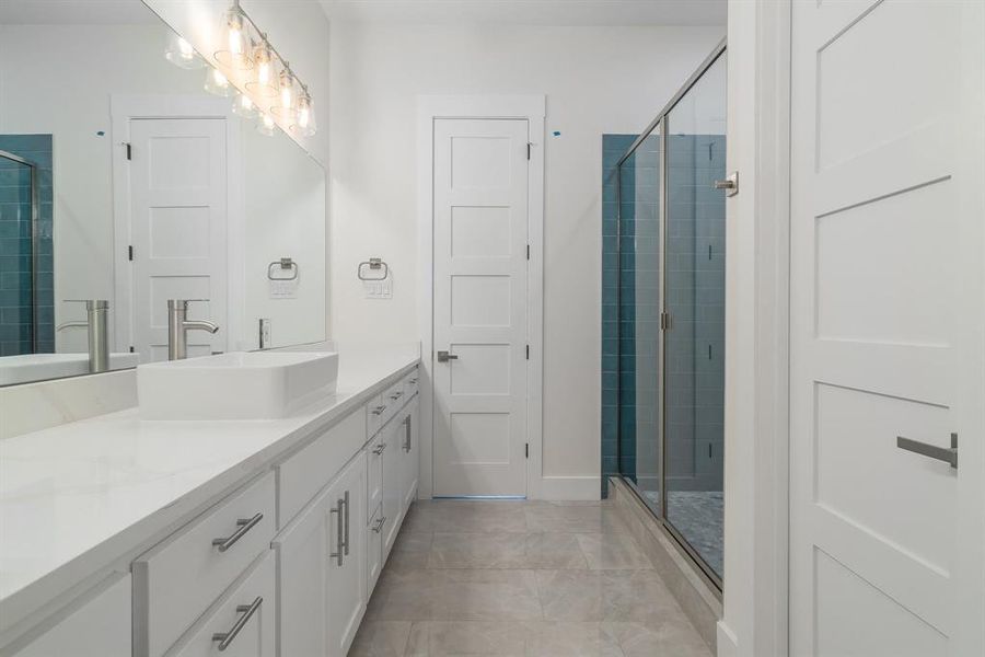 Bathroom featuring vanity, tile patterned flooring, and an enclosed shower