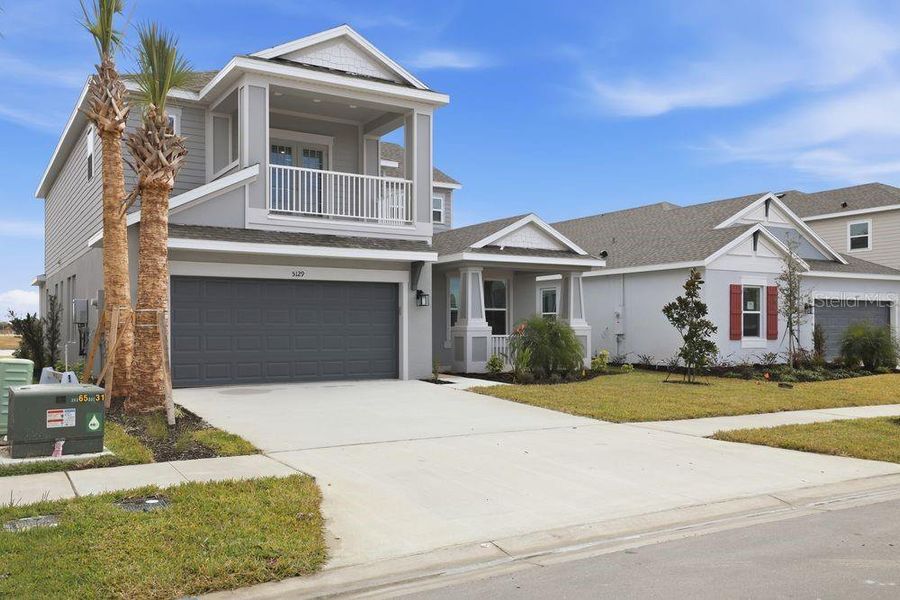 Front exterior of a new home in Indigo Creek, Apollo Beach, FL, highlighting curb appeal (Image 22).