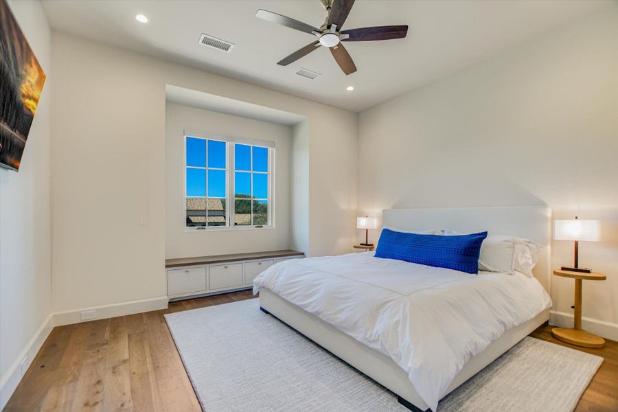 Bedroom with light wood-style floors, a ceiling fan, and recessed lighting