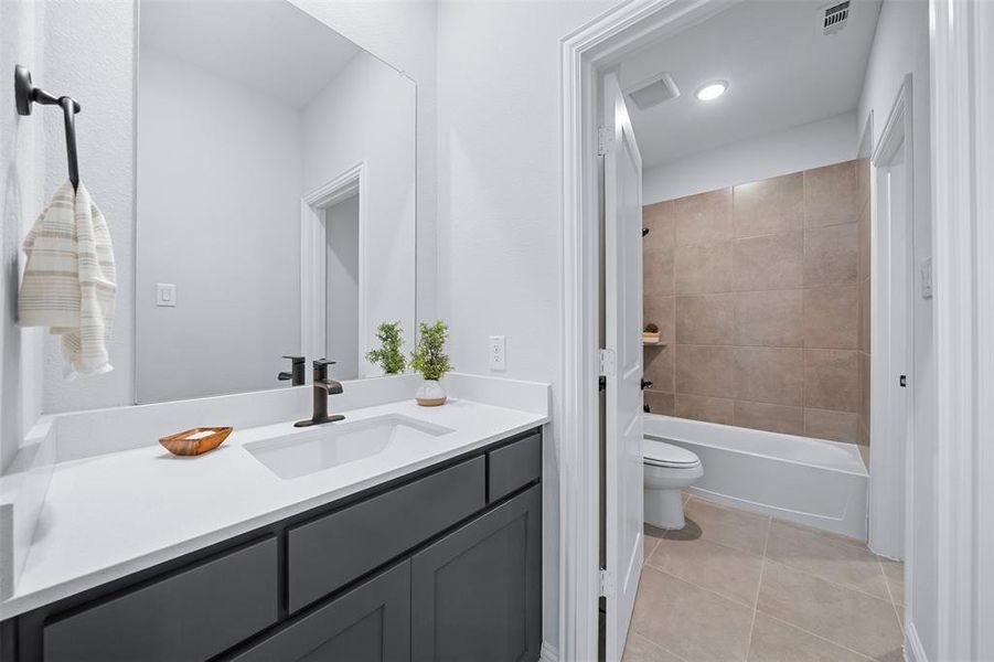 Full bathroom with vanity, tile patterned floors, and bathtub / shower combination
