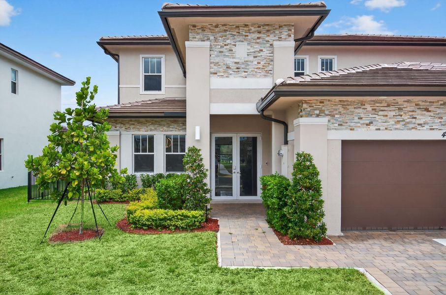 Front exterior of a new home in , Davie, FL, highlighting curb appeal (Image 1).