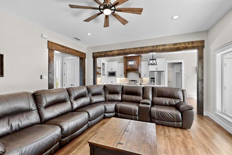 Living area featuring ceiling fan, light wood-type flooring, and recessed lighting