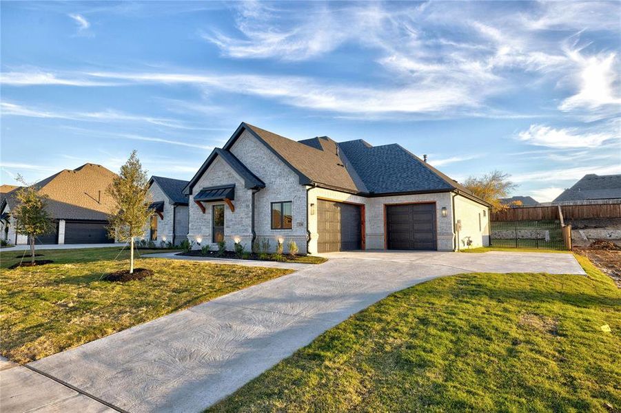 View of front facade with a front lawn and a garage