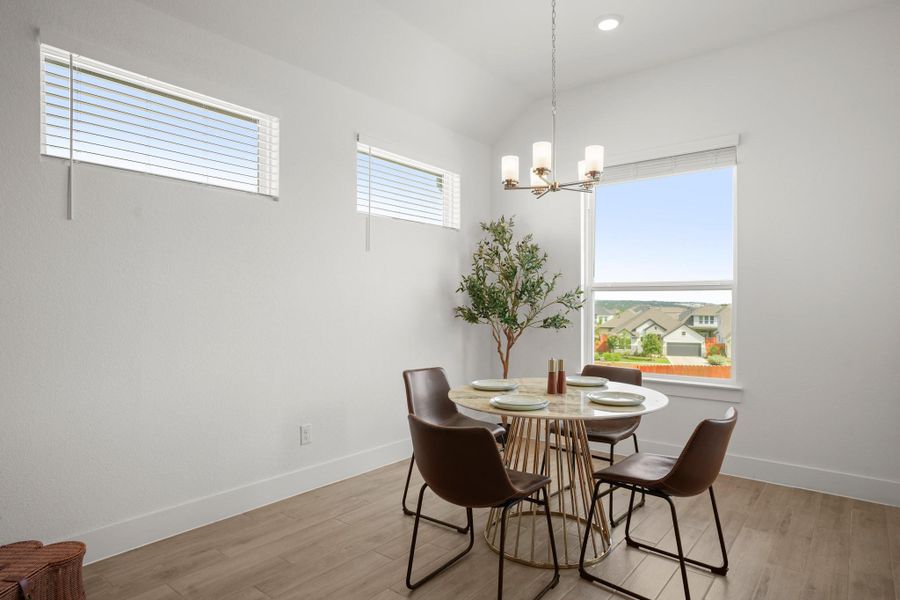 A well-lit dining area offers a seamless flow with an open floorplan, perfect for everyday meals.