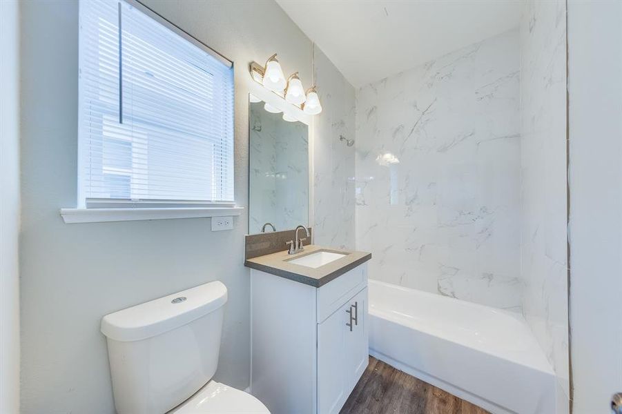 The secondary bathroom features a stylish design, complete with a convenient tub-shower combo that caters to both quick routines and leisurely baths. Modern fixtures and ample storage make it functional and user-friendly, while its aesthetic ties in beautifully with the rest of the home.