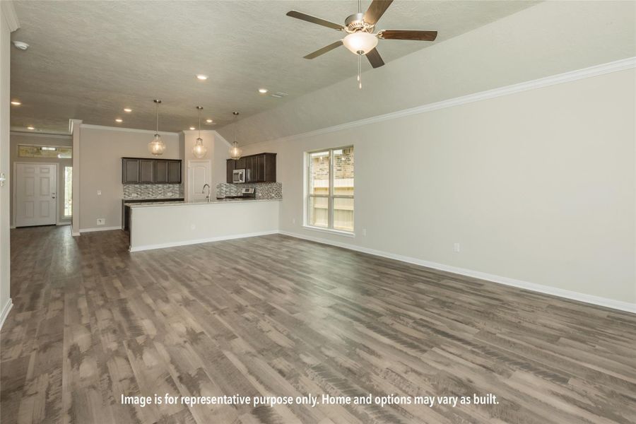 Unfurnished living room featuring ceiling fan, crown molding, dark wood-type flooring, and recessed lighting