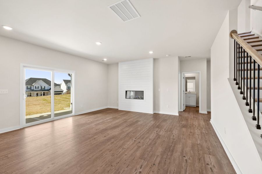 A large empty room with a wood floor. A large empty room with a wood floor.