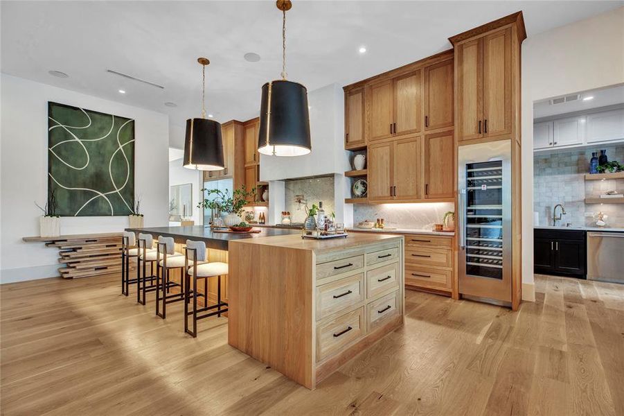 Kitchen with open shelves, tasteful backsplash, beverage cooler, light wood-style flooring, and recessed lighting Kitchen with open shelves, tasteful backsplash, beverage cooler, light wood-style flooring, and recessed lighting