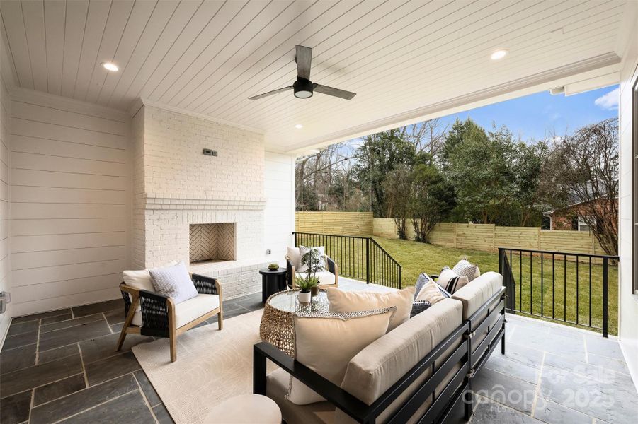 The covered porch looks onto the flat, .44-acre lot.