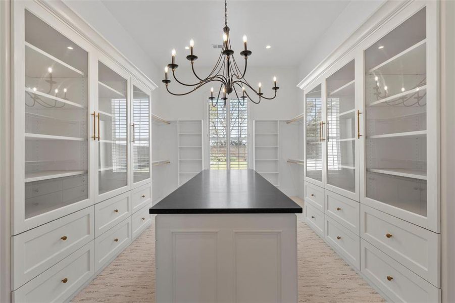 Spacious closet featuring a chandelier