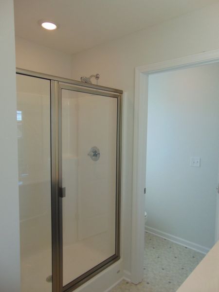 The primary bathroom has a soak in tub and shower, as well as two sinks.