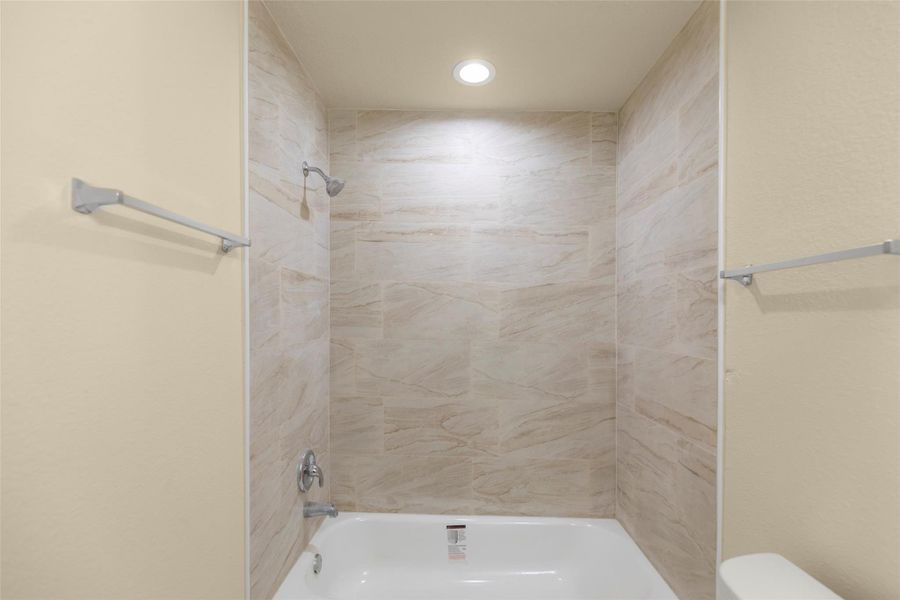 Bright, cozy room with soft beige walls and carpet. Features two large windows for natural light, recessed lighting, and a ceiling fan for comfort. Bright, cozy room with soft beige walls and carpet. Features two large windows for natural light, recessed lighting, and a ceiling fan for comfort.