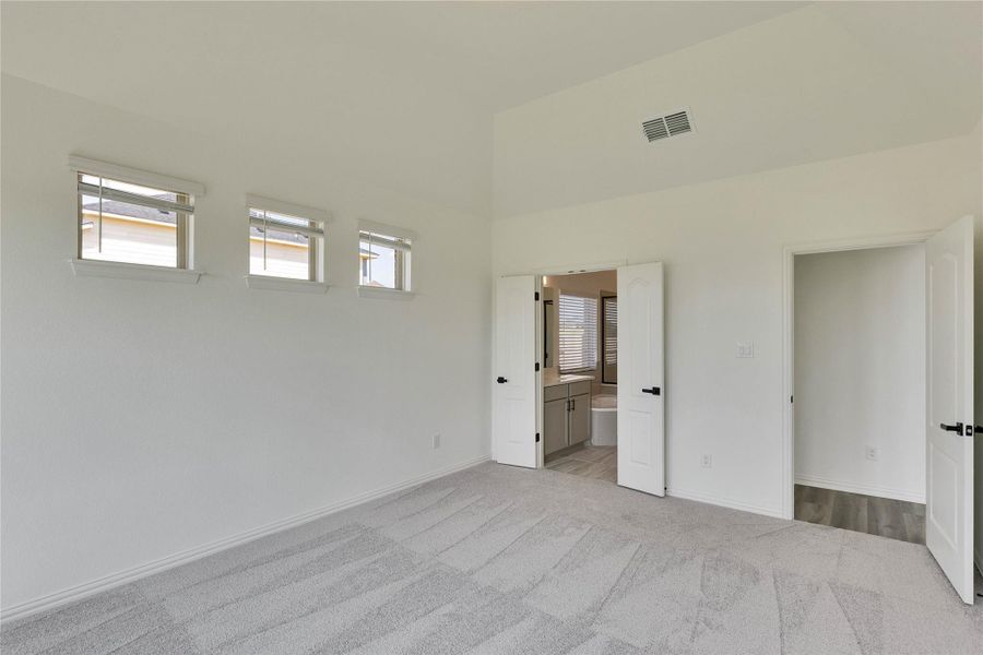 Unfurnished bedroom with carpet flooring and ensuite bath
