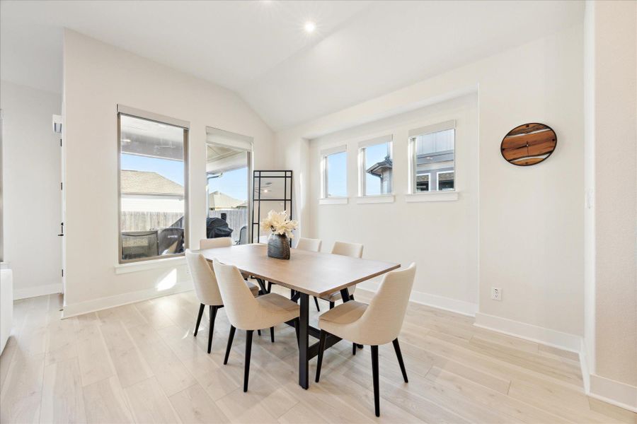 Dining room with beautiful windows.  6" baseboards and decorative ceiling detail.