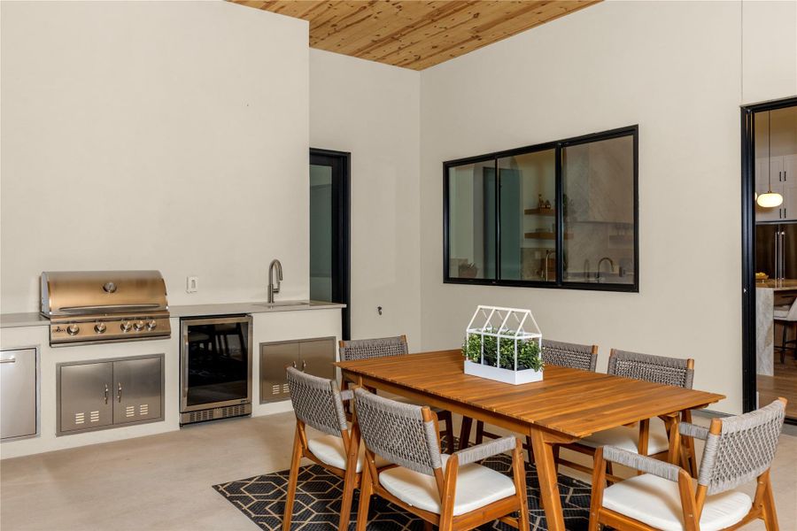 Dining area with beverage cooler and wooden ceiling