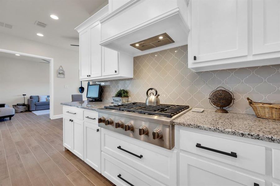 36" GE Cafe Gas cooktop is a bonus as is the upgraded backsplash! Drawers upon drawers make storing and retrieving dishes a breeze.