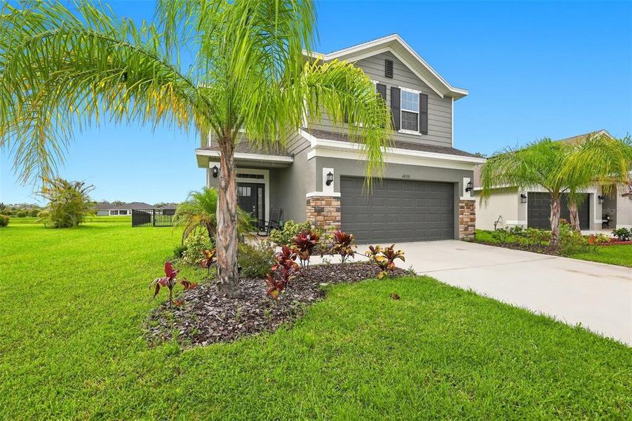 Front exterior of a new home in Aviary at Rutland Ranch, Parrish, FL, highlighting curb appeal (Image 20). Front exterior of a new home in Aviary at Rutland Ranch, Parrish, FL, highlighting curb appeal (Image 20).