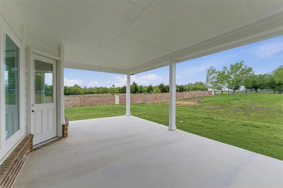 The property features a spacious covered patio with a concrete floor