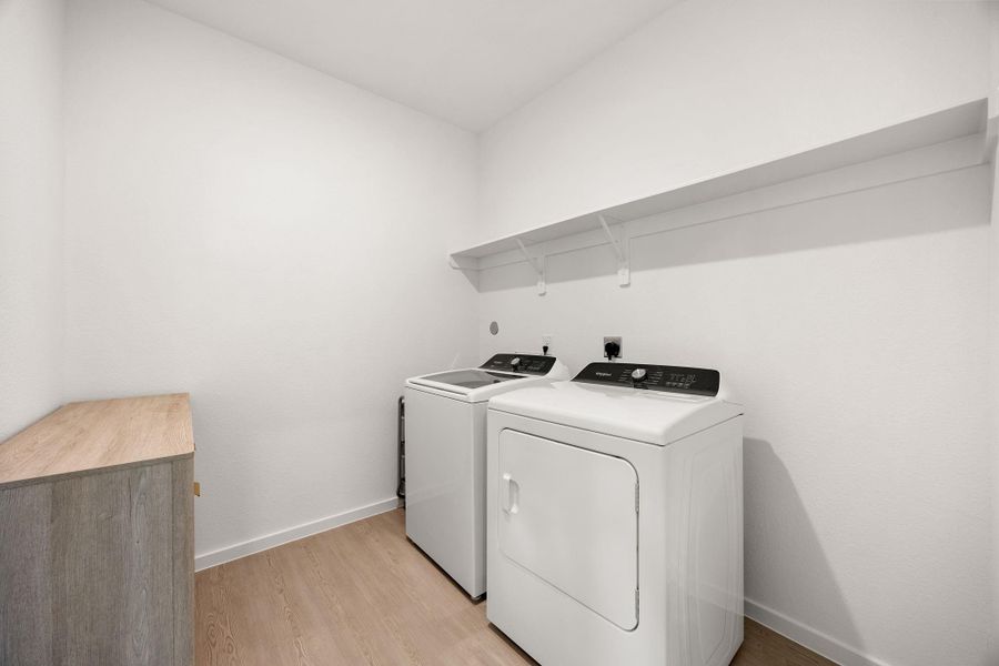 Convenient indoor utility room with additional storage space. Refrigerator, washer, and dryer are included, making this home truly move-in ready.