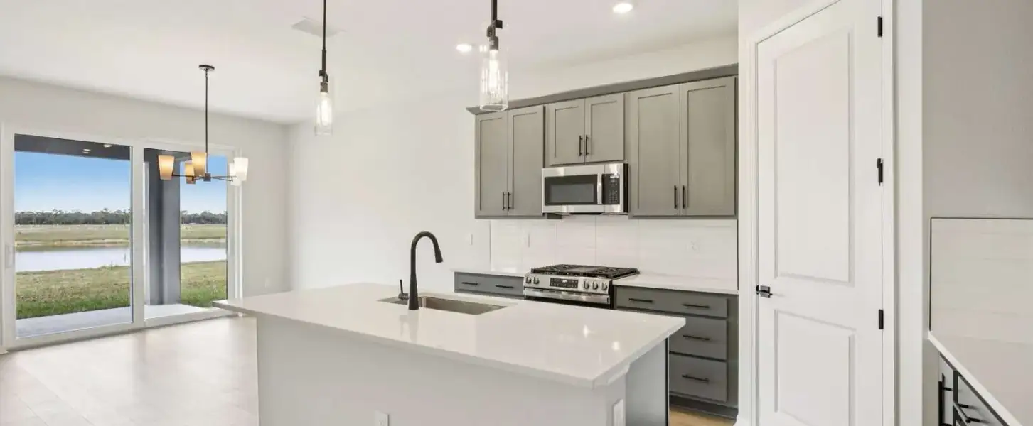 Spacious kitchen layout with a corner pantry - this home will feature the AW Collection® Coastal - Representative images and renderings are for illustrative purposes. Actual structural options and design finishes of home may vary.