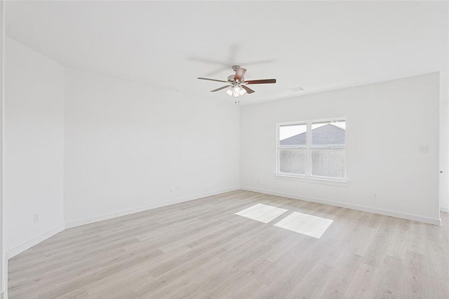 Spare room with light hardwood / wood-style floors and ceiling fan