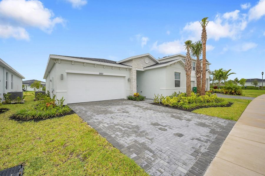 Front exterior of a new home in Seagrove: The Indies, Fort Pierce, FL, highlighting curb appeal (Image 14). Front exterior of a new home in Seagrove: The Indies, Fort Pierce, FL, highlighting curb appeal (Image 14).