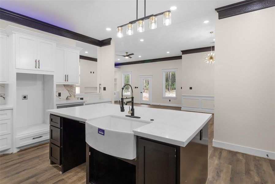 Love this farmhouse sink! The island color is the perfect contrast to really make it stand out and allows plenty of space on the other side for bar stools to make this area the perfect gathering place for family and friends.