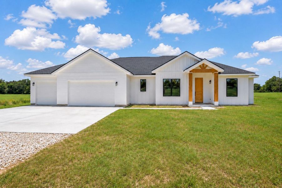 Front exterior of a new home in , Thrall, TX, highlighting curb appeal (Image 1). Front exterior of a new home in , Thrall, TX, highlighting curb appeal (Image 1).