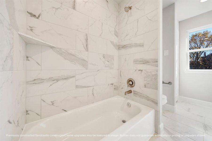 The bathroom includes a practical tub/shower combo with a standard shampoo ledge, along with a commode and a handy linen closet for all your storage needs.