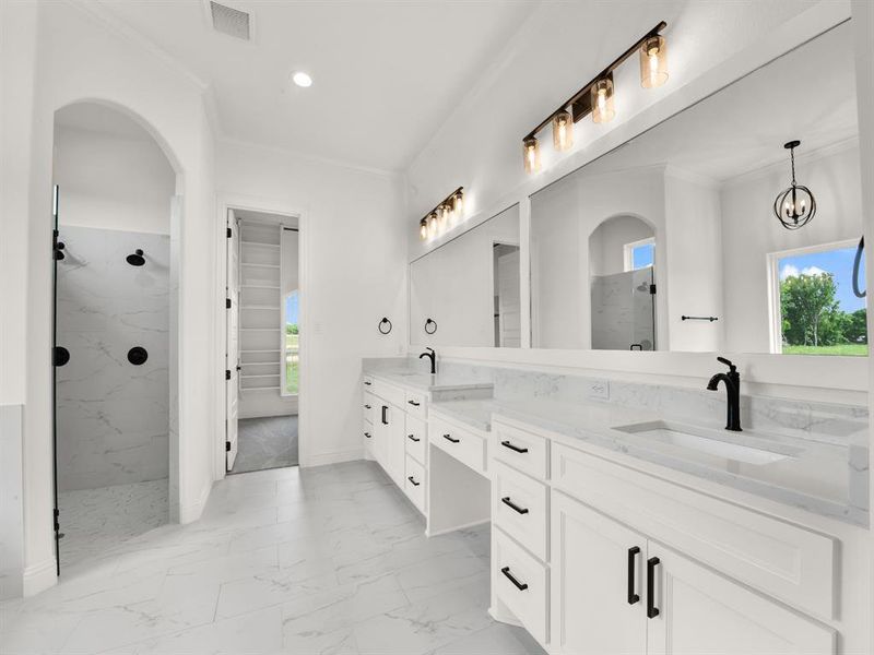 Bathroom featuring crown molding, marble look tile flooring, a marble finish shower, double vanity, and recessed lighting