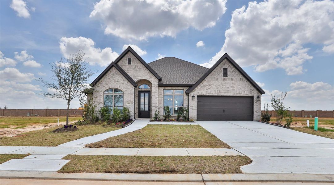 Front exterior of a new home in Everly, Hockley, TX, highlighting curb appeal (Image 2).