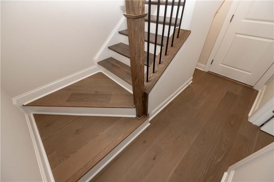 Staircase  to terrace level bedroom and 2 car garage featuring wood finished floors. Image is of previously built Chamberlain