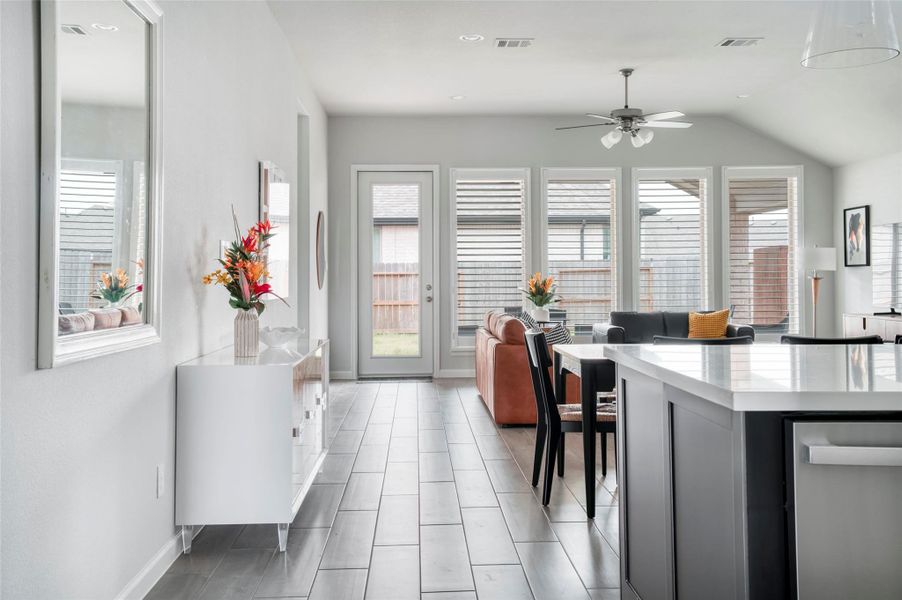 This open-concept living area features modern design with large windows for ample natural light, sleek flooring, and a stylish kitchen island. The space is perfect for entertaining and offers a seamless flow to the outdoor area. This open-concept living area features modern design with large windows for ample natural light, sleek flooring, and a stylish kitchen island. The space is perfect for entertaining and offers a seamless flow to the outdoor area.