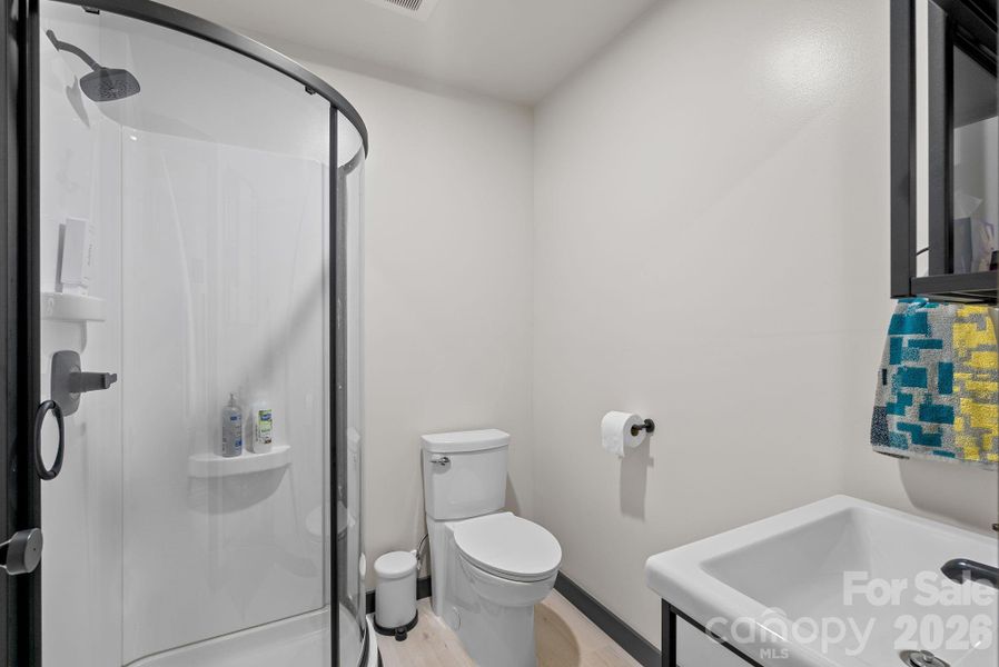 Lower level bathroom includes a step in shower .